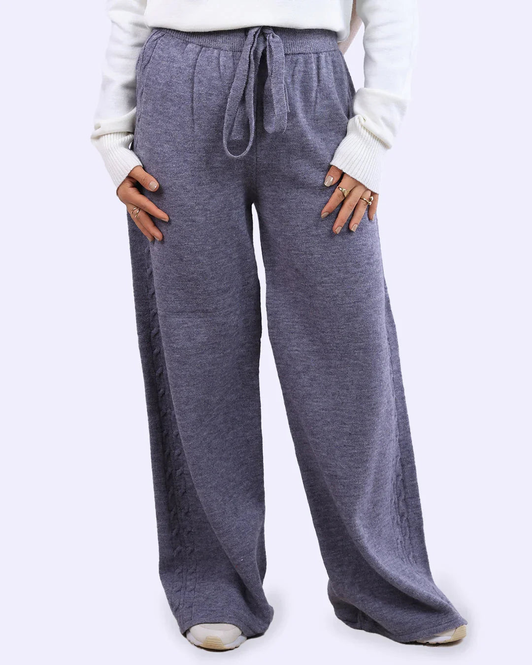 Woman wearing gray wide-leg knit pants with drawstring waist from WIND Shopping