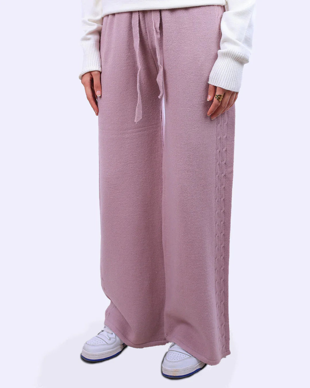 Light purple knit wide-leg pants with drawstring waist, styled with white sweater and sneakers