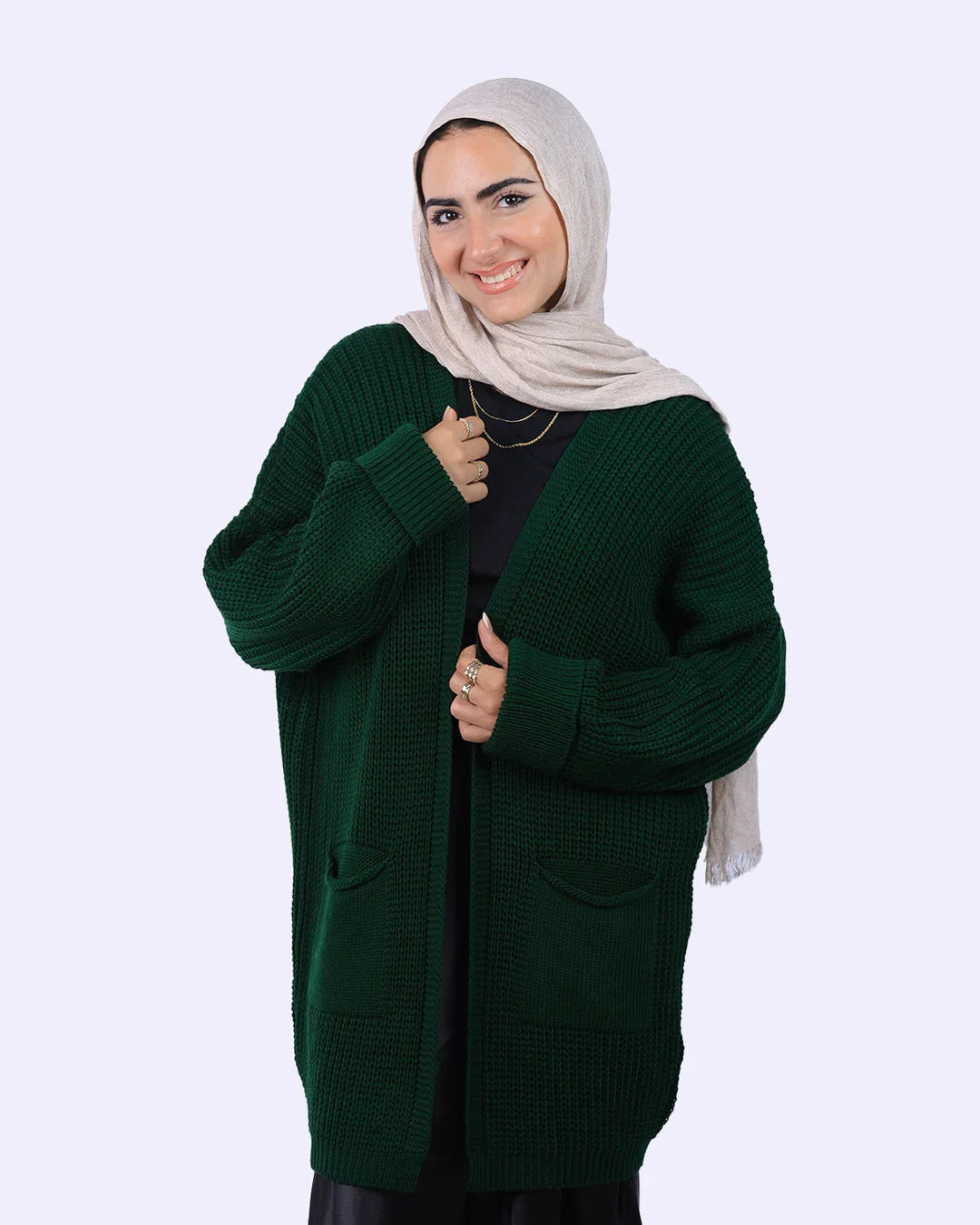 Woman in beige hijab and dark green knit cardigan from WIND Shopping fashion collection