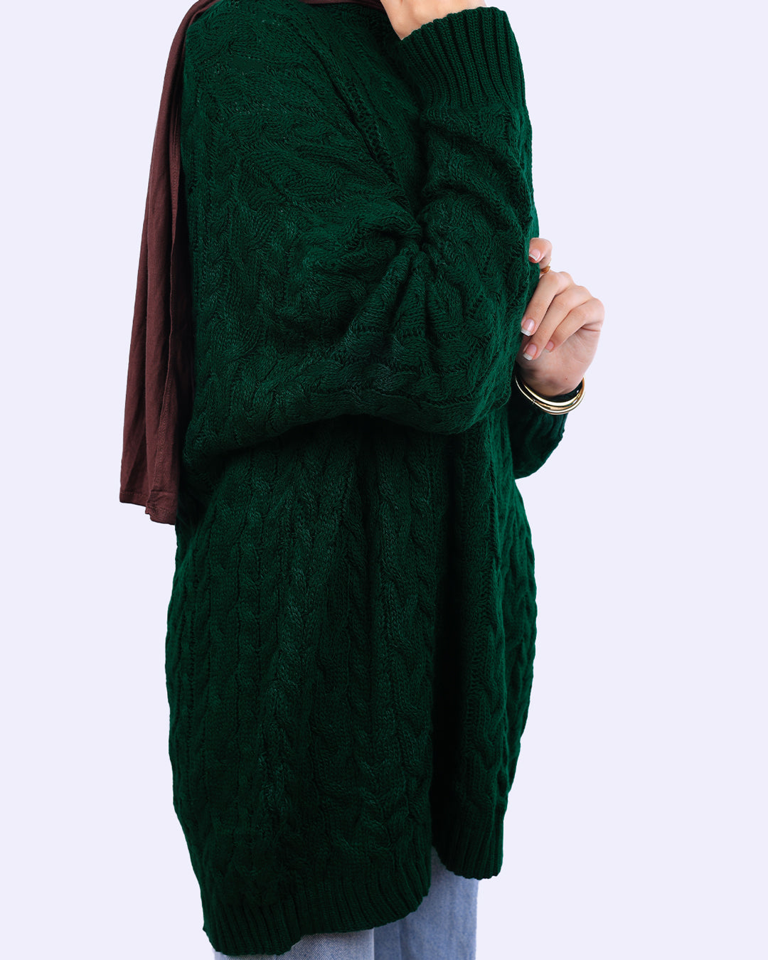 Woman wearing a dark green cable knit sweater from WIND Shopping, side view, casual style