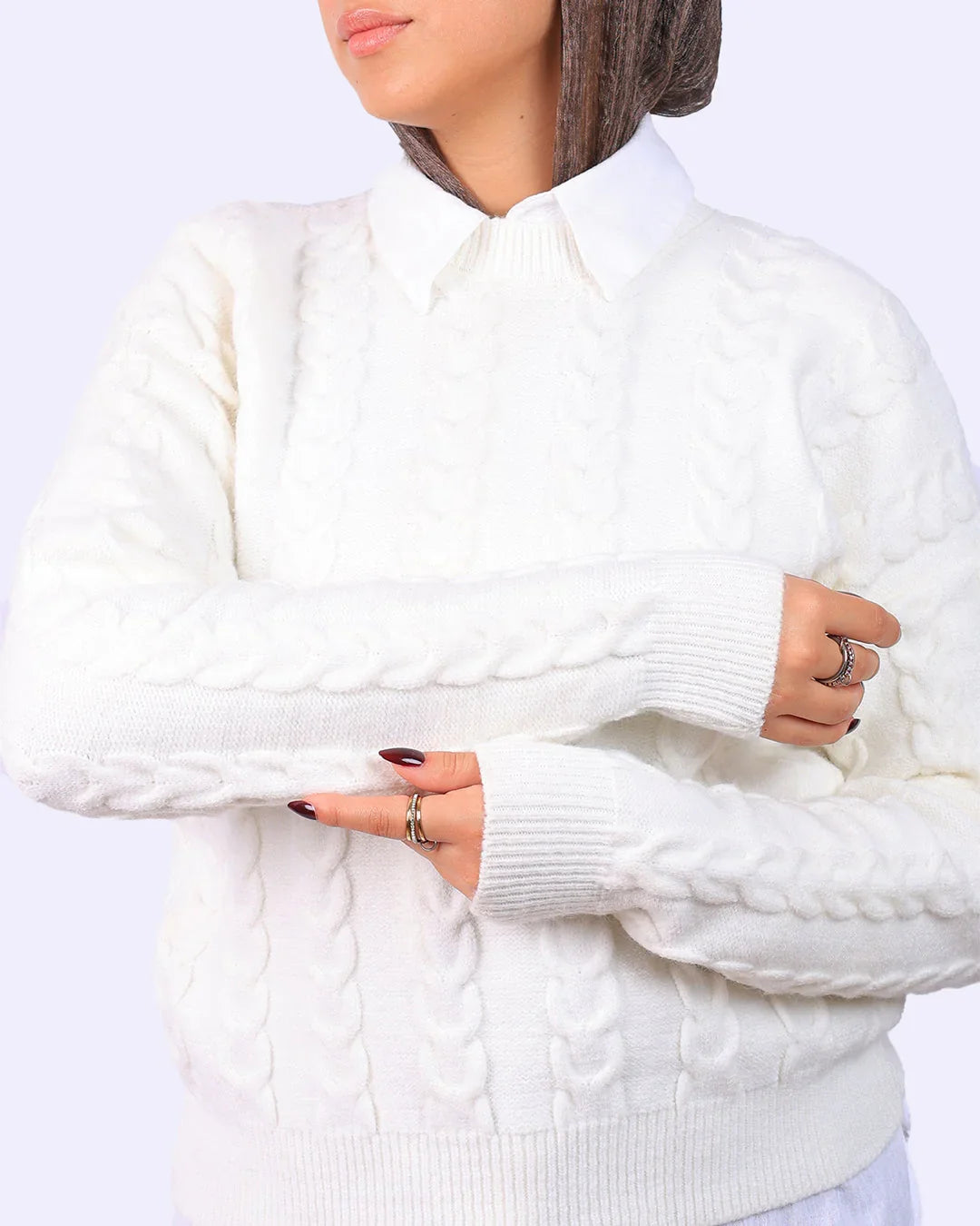 Woman wearing a white cable knit sweater over a collared shirt from WIND Shopping Egypt