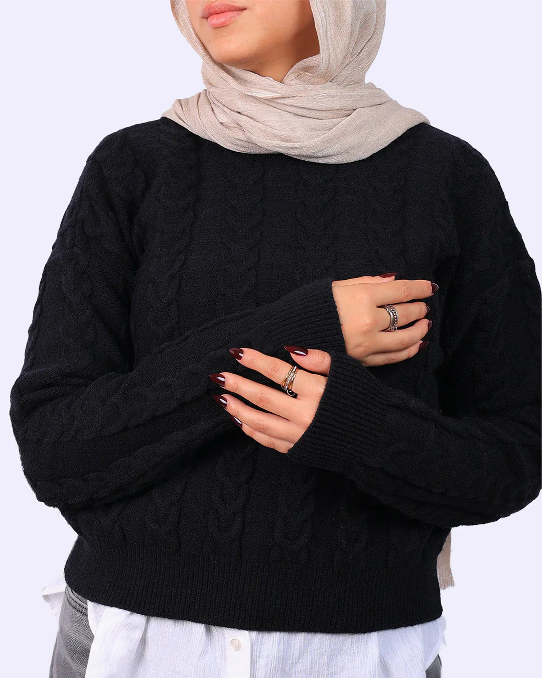 Woman wearing black cable knit sweater and beige hijab from WIND Shopping fashion collection