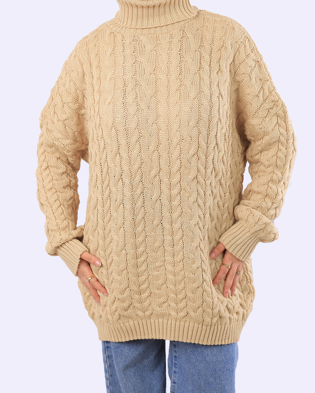 Beige cable knit turtleneck sweater from WIND Shopping, styled with blue jeans.