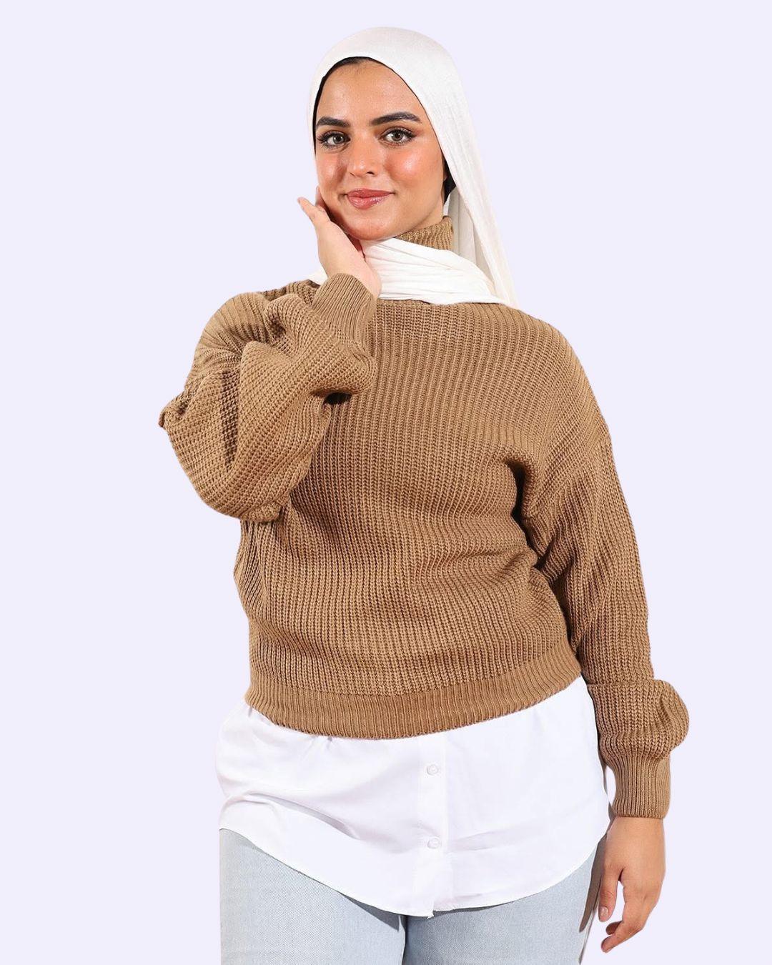 Woman in beige knit sweater, white shirt, and hijab posing for WIND Shopping fashion in Egypt