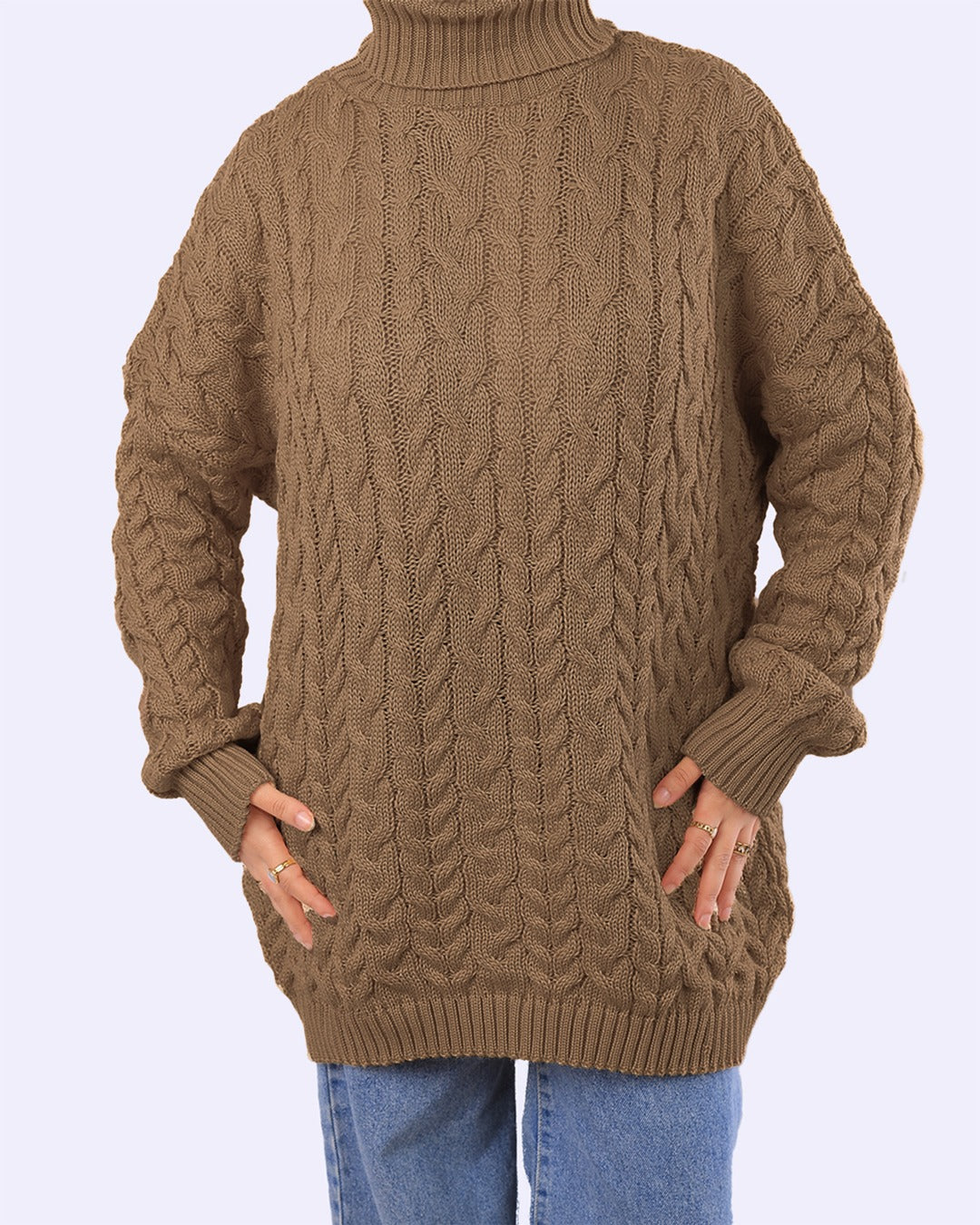 Brown cable-knit turtleneck sweater with long sleeves, styled with blue jeans on WIND Shopping.