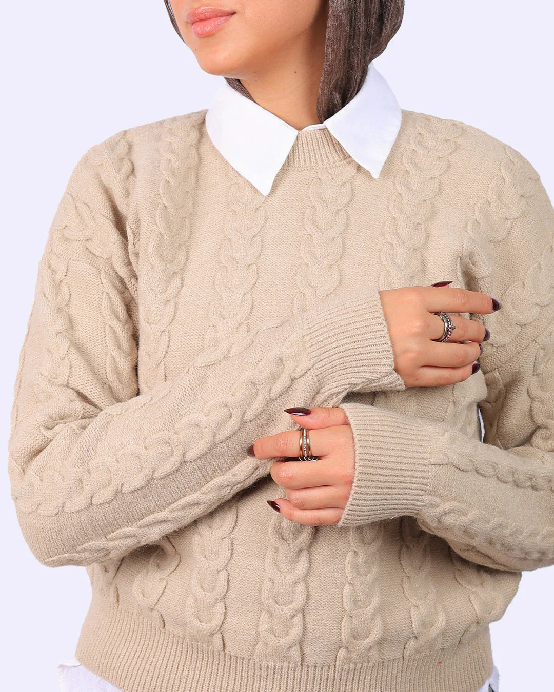 Woman wearing beige cable knit sweater over white shirt, fashion from WIND Shopping Egypt