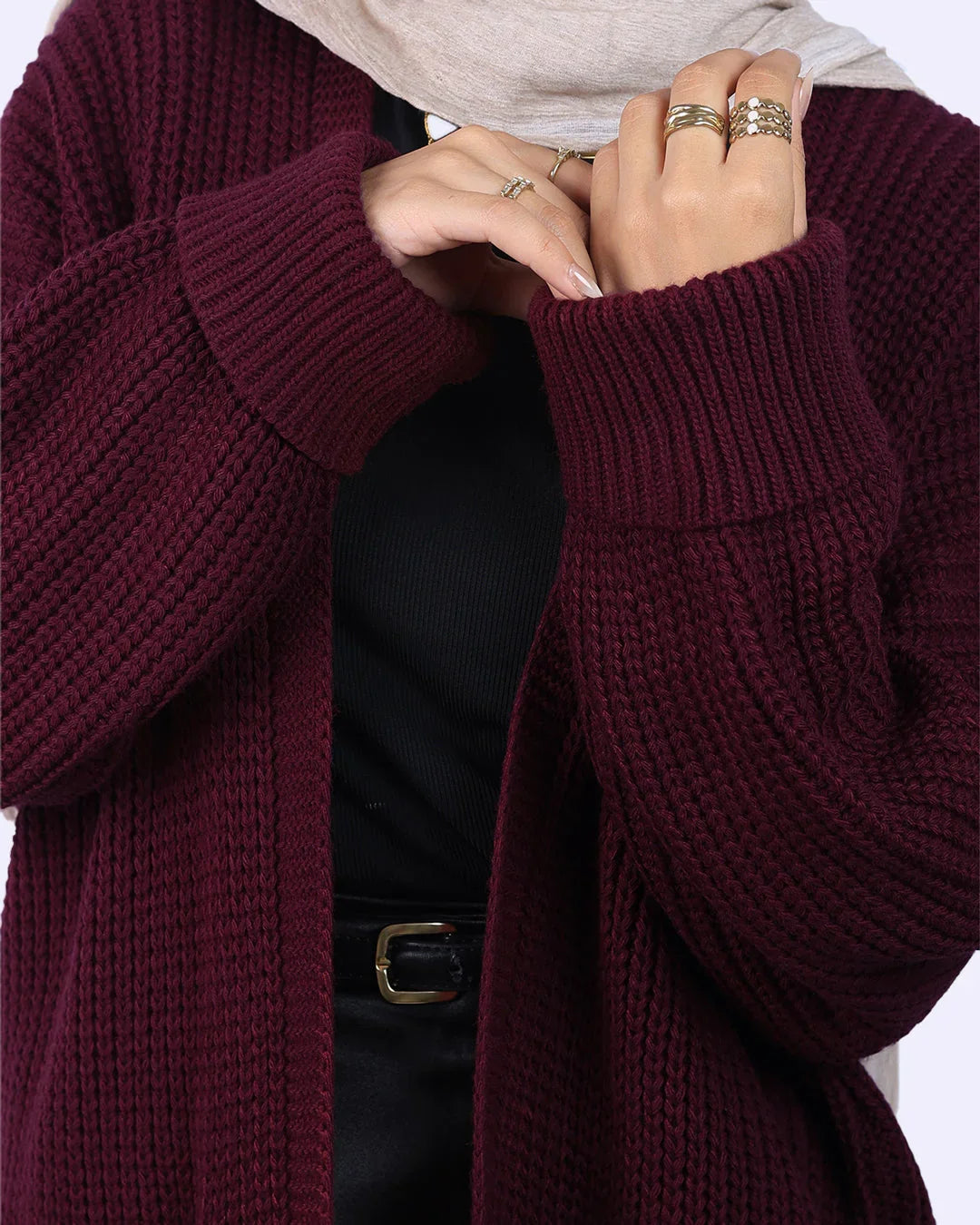 Woman wearing a burgundy knit cardigan and black top from WIND Shopping Egypt
