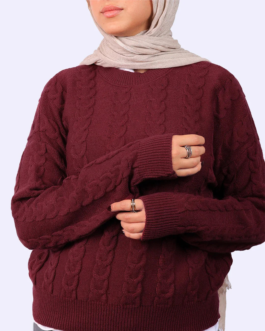 Woman in maroon cable knit sweater and beige hijab from WIND Shopping Egypt fashion collection