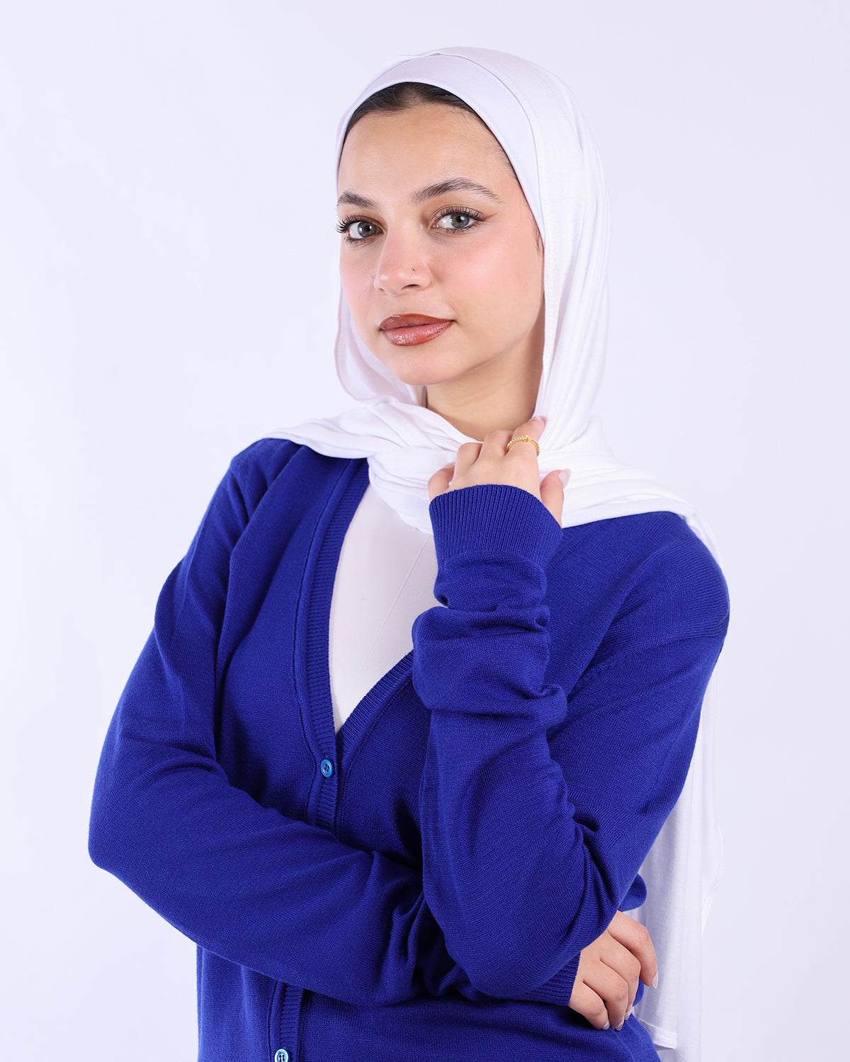 Woman wearing a blue cardigan and white hijab on a white background-WIND Shopping
