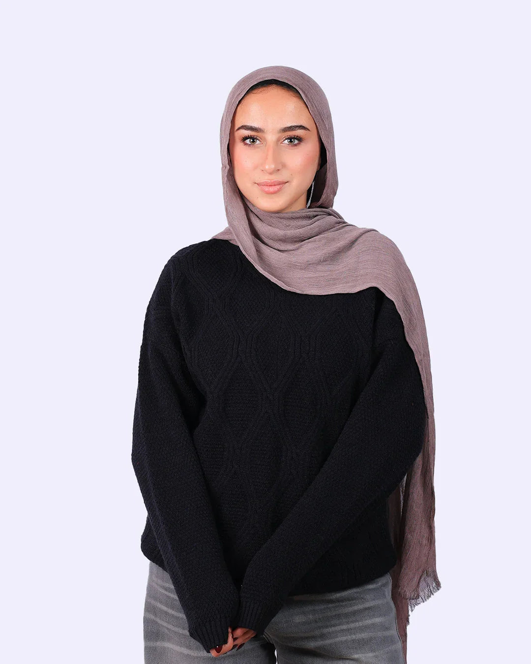 Woman in taupe hijab, black textured sweater, and grey jeans, WIND Shopping fashion.