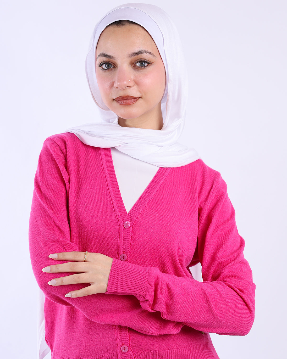 Woman wearing a pink cardigan and white hijab on a white background-WIND Shopping