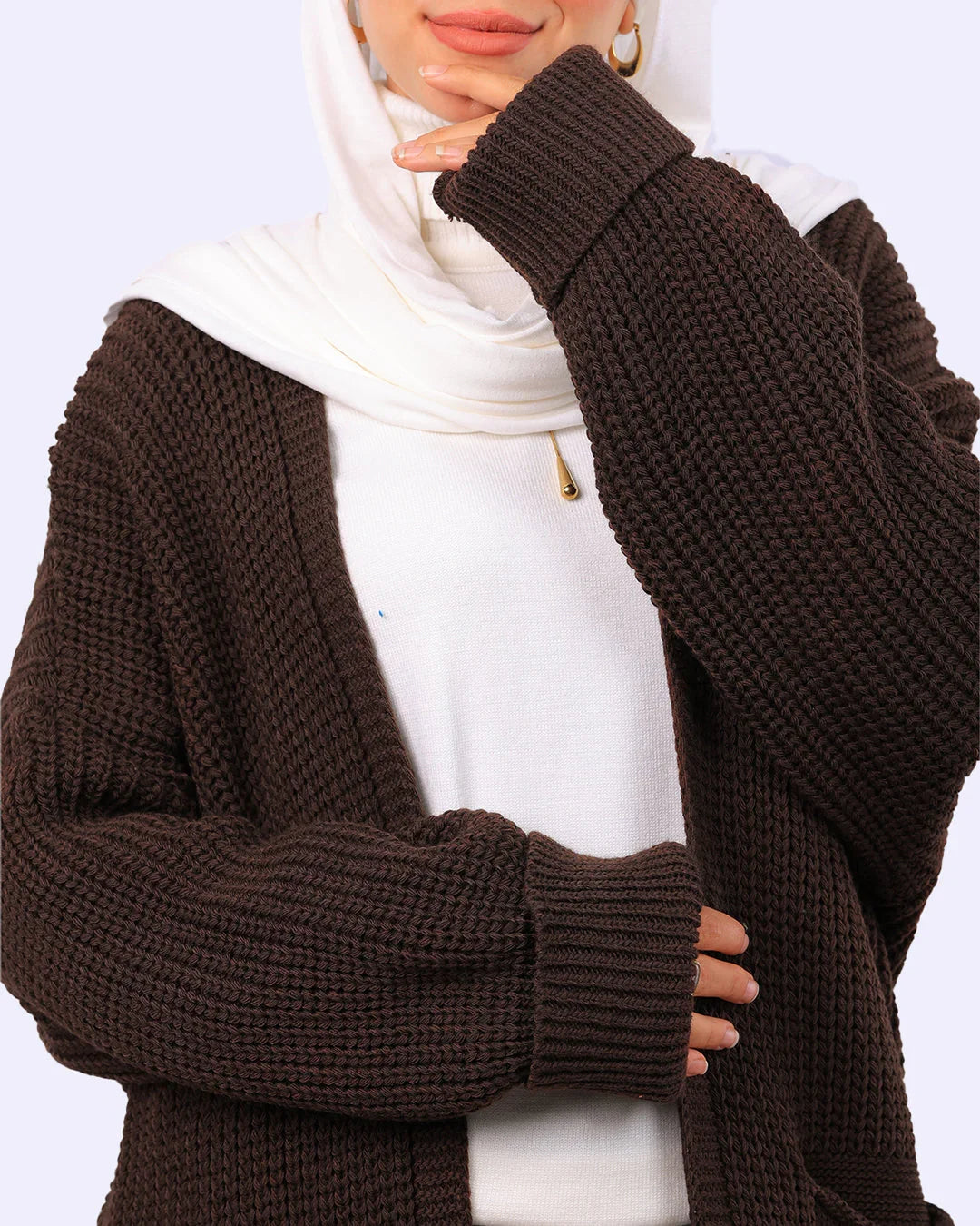 Woman wearing a brown knit cardigan over a white top and white hijab, WIND Shopping fashion
