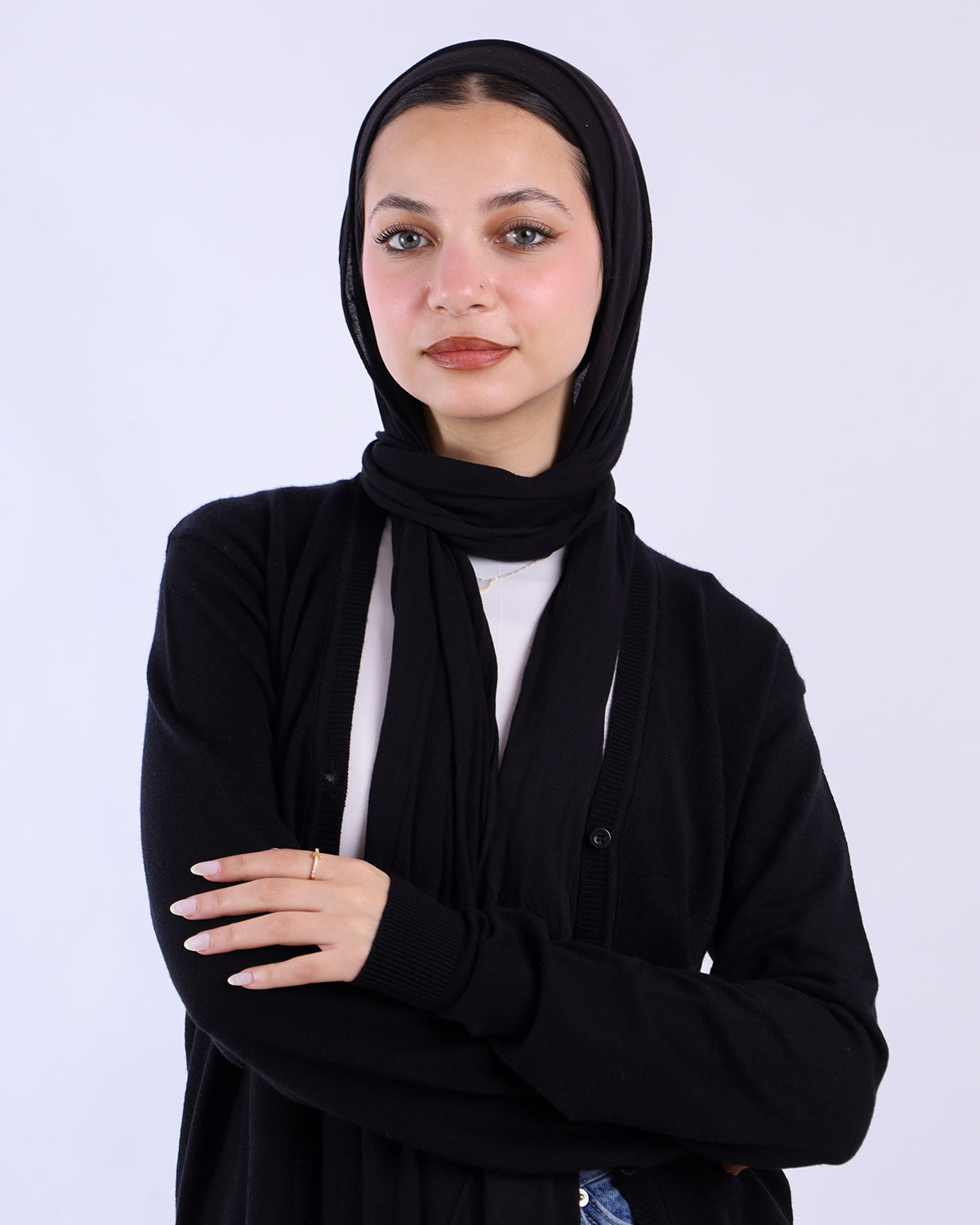 Woman wearing a black hijab and black cardigan against a white background-WIND Shopping