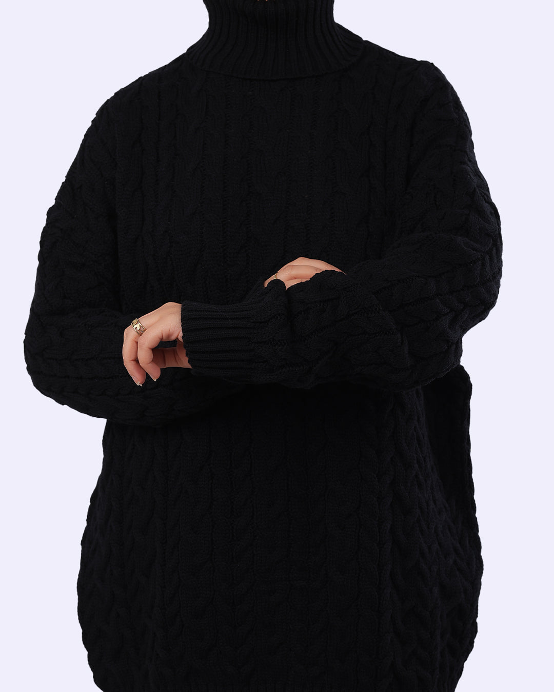 Black cable knit turtleneck sweater from WIND Shopping, shown on model against light background
